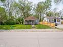 Exterior view of the home with well maintained lawn and neighborhood views at 1132 Sharon Ave, Indianapolis, IN 46222