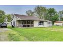 Cozy single-story home with a screened-in porch and a large, green front lawn at 115 S Center St, Maxwell, IN 46154