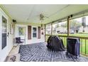 Inviting screened-in porch featuring outdoor furniture, ceiling fan, and a cozy atmosphere at 115 S Center St, Maxwell, IN 46154