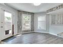 Bright breakfast nook featuring wood paneled walls, a large window and door, and gray wood-look flooring at 11614 Buttonwood Dr, Carmel, IN 46033