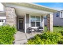 Inviting covered front porch with stone columns and a cozy seating area at 1289 Sunset Blvd, Avon, IN 46123