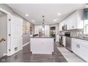 Bright kitchen featuring a central island, stainless steel appliances, and stylish white cabinetry at 13131 Conner Knoll Pkwy, Fishers, IN 46038