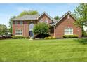 Beautiful two-story brick house with large front lawn and professional landscaping at 13248 Blacktern Way, Carmel, IN 46033