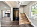 Welcoming entryway featuring wood floors, a built-in mudroom bench, and staircase at 1601 E Edwards Ave, Indianapolis, IN 46227