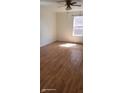 A bright bedroom featuring new, light-colored laminate wood flooring, ceiling fan and a window at 1632 W 8Th W St, Anderson, IN 46016