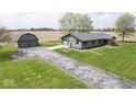 Charming single-story home boasts a spacious two-car garage and well-manicured lawn at 1737 W 1000 N, Alexandria, IN 46001