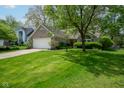 Attractive single-story brick home showcasing a lush green lawn and mature trees shading the property at 19519 Creekview Dr, Noblesville, IN 46062