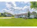 Charming single-story home featuring a two car garage, a well manicured lawn and basketball court at 2237 W 100 N, Greenfield, IN 46140