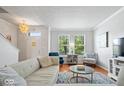 Bright living room featuring hardwood floors, neutral paint, windows and lots of natural light at 2405 N Park Ave, Indianapolis, IN 46205