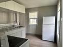 An efficient kitchen design featuring white cabinets, granite countertops, and modern appliances at 3114 Adams St, Indianapolis, IN 46218