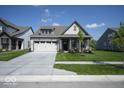 Well-maintained home featuring a lawn, attached garage, and neat landscaping at 345 Ehrlich Ln, Westfield, IN 46074
