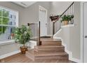 Inviting home entryway with hardwood floors, wooden staircase and a large window that provides natural light at 3546 Brampton Ln, Westfield, IN 46074