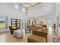 Spacious living room featuring a high ceiling, modern chandelier, and an open floor plan to the kitchen at 4078 Besbie Way, Bargersville, IN 46106