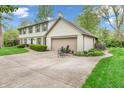 Spacious driveway leading to a two-car garage, with chairs set up for relaxation at 4232 Briarwood Dr, Indianapolis, IN 46250
