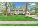 Two-story home featuring a well-kept lawn and a classic exterior design at 4232 Briarwood Dr, Indianapolis, IN 46250