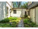 A tranquil courtyard view features stone pathways and lush greenery with stucco walls at 4302 Kessler Blvd N Dr, Indianapolis, IN 46220