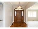 Welcoming entryway featuring hardwood floors, elegant lighting, and a decorative wooden door with sidelights at 4351 W Fox Ridge Ave, Greenwood, IN 46143
