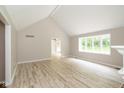 Bright and spacious living room featuring a vaulted ceiling, large windows, and neutral flooring at 4351 W Fox Ridge Ave, Greenwood, IN 46143