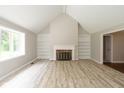 Bright living room with a fireplace, built-in shelving, large windows, and neutral flooring at 4351 W Fox Ridge Ave, Greenwood, IN 46143