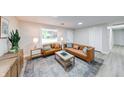 Bright living room featuring modern furniture, neutral walls, decorative rug, recessed lighting, and large front window at 444 Buffalo Dr, Indianapolis, IN 46217