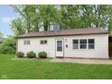 Classic single-story home featuring white siding and a well-kept lawn with mature trees at 4716 E 33Rd St, Indianapolis, IN 46218