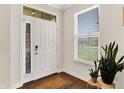 Well lit entry featuring a traditional white door, hardwood floors, side window, and plants at 4965 Eldon Dr, Noblesville, IN 46062