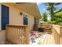 Inviting back porch with a cozy seating area and colorful rug, providing a relaxing outdoor space with a homey touch at 5015 E 70Th E St, Indianapolis, IN 46220
