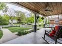 Inviting front porch features a wood ceiling, swing, and comfortable seating at 5224 Boulevard Pl, Indianapolis, IN 46208
