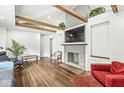 Cozy living room with hardwood floors, stone fireplace, exposed wood beams, and comfortable seating at 6401 N Oakland Ave, Indianapolis, IN 46220