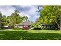 Inviting single-story home with a well-manicured lawn and mature trees at 7770 N Pennsylvania St, Indianapolis, IN 46240