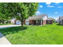 Charming single-story brick home with a well-maintained lawn and inviting curb appeal at 8145 Bentley Farms Dr, Indianapolis, IN 46259