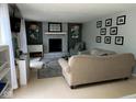 Comfortable living room features a brick fireplace, neutral decor, and ample seating at 8507 Promontory Rd, Indianapolis, IN 46236