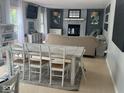 Spacious and well-lit living area with fireplace and large dining table at 8507 Promontory Rd, Indianapolis, IN 46236