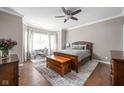 Serene bedroom with hardwood floors, a cozy bed, and large windows offering natural light at 863 N Park Trail Dr, Carmel, IN 46032