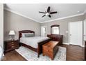 Comfortable bedroom with hardwood floors, complemented by neutral tones, furniture, and ceiling fan at 863 N Park Trail Dr, Carmel, IN 46032
