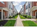 Inviting walkway lined by lush greenery, leading through a community of well-maintained townhomes at 863 N Park Trail Dr, Carmel, IN 46032