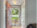 Inviting entryway with a solid wood door and views of the bright outdoors at 8636 Rockville Rd, Indianapolis, IN 46234