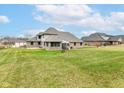 Spacious backyard featuring a well-maintained lawn and charming architecture of the home at 941 W Barouche, Pendleton, IN 46064