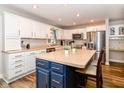 Bright kitchen with a large island, white cabinets, stainless steel appliances, and a built-in desk at 941 W Barouche, Pendleton, IN 46064