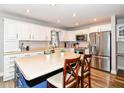 Bright kitchen with a large island, white cabinets, stainless steel appliances, and lots of counter space at 941 W Barouche, Pendleton, IN 46064
