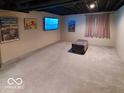 Finished basement with modern design touches, flat screen TV, and sleek lighting at 9879 Brightwater Dr, Fishers, IN 46038