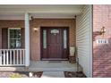 Inviting entryway featuring a brick facade, decorative glass door, and classic outdoor lighting fixtures at 9910 Suncoral Cir, Fishers, IN 46038
