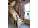 Interior staircase being built with exposed framework and a nearby window at 1041 Fuller Ln, Shelbyville, IN 46176