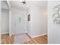 Bright entryway with hardwood floors, white walls, and decorative accents at 10444 Collingswood Ln, Fishers, IN 46037
