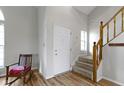 Bright foyer featuring a staircase with wooden banister and views of the living area with beautiful floors at 10616 Bartley Dr, Indianapolis, IN 46236