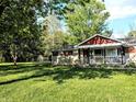 Charming home exterior featuring a well-manicured lawn and mature trees at 10751 N Kitchen Rd, Mooresville, IN 46158