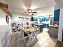 Charming eat-in kitchen with stylish blue cabinets, updated fixtures, and tile floors at 10751 N Kitchen Rd, Mooresville, IN 46158