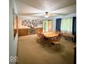 Bright dining area boasts a wooden table set, Gathering photo decor, and natural light from the window at 10946 Maze Rd, Indianapolis, IN 46259