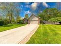 Lovely home featuring a two-car garage, brick accents, and a well-kept lawn with mature trees at 1120 Crystal Ct, Avon, IN 46123