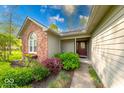 Inviting front entrance with brick accents, colorful landscaping, and a decorative front door at 1120 Crystal Ct, Avon, IN 46123